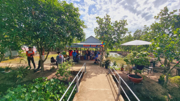 Stop at fruits garden to drink local coffee on the way of cycling tour